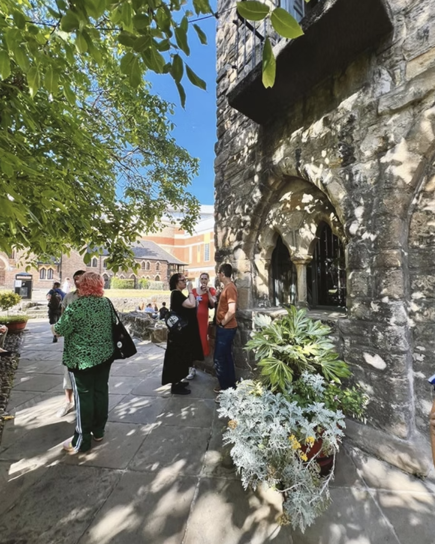Candid moment of attendees talking in Blackfriars courtyard