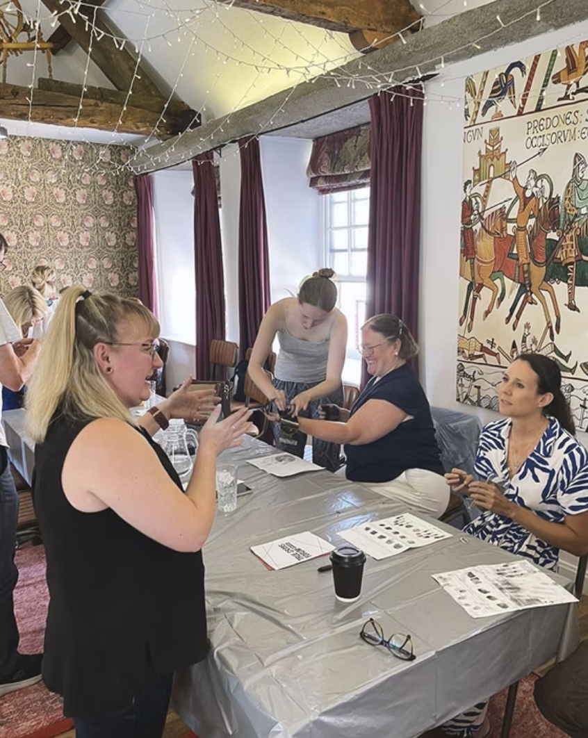 Attendees examining timeline evidence and taking fingerprints
